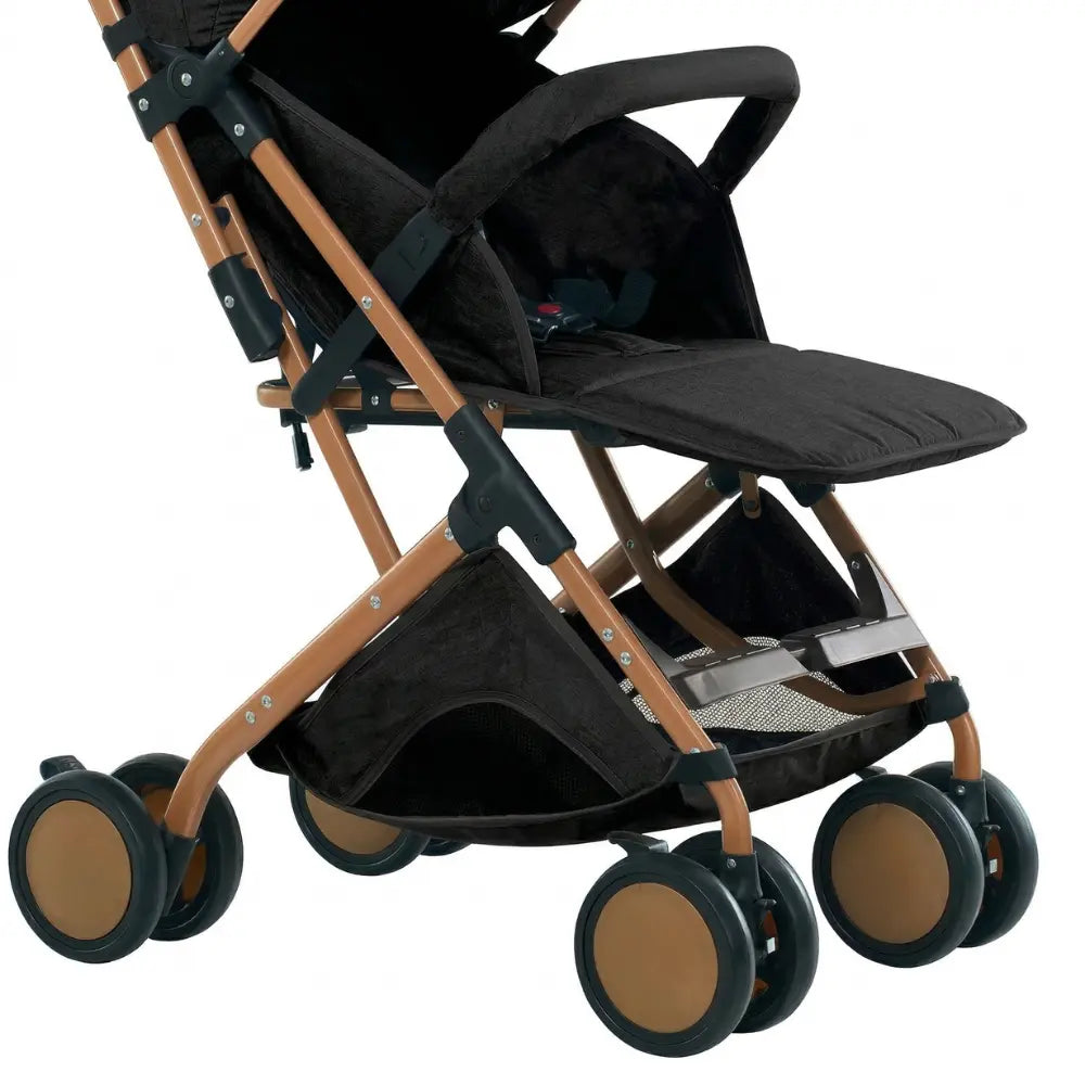 Poussette bebe pliable noir avec chassis dore design compact maniable ideale pour ville voyages et sorties quotidiennes