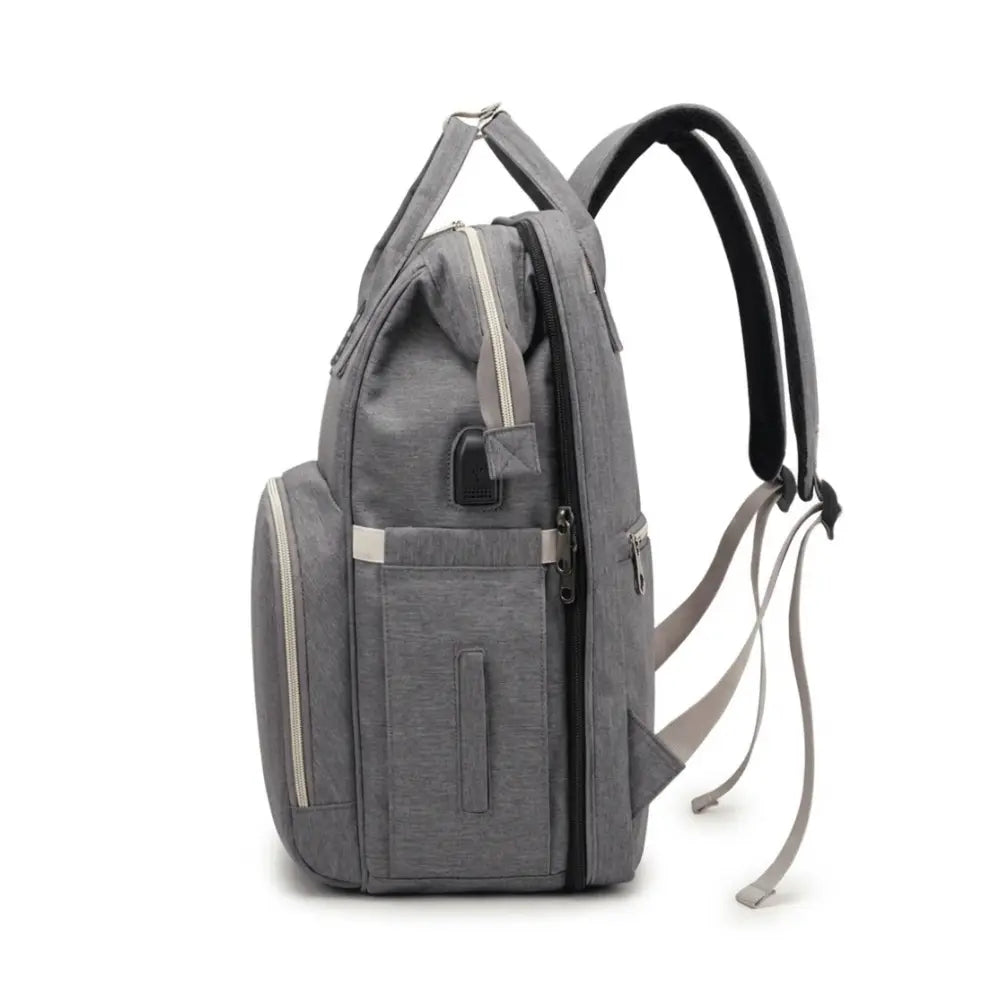 Sac a dos a langer bebe gris avec poches laterales multiples port usb integre et design ergonomique moderne